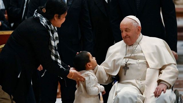 Un niño saluda al Papa.