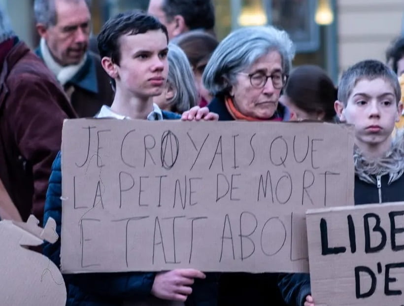 Yo creía que la pena de muerte estaba abolida, dice este cartel en francés en protesta por el aborto en la Constitución