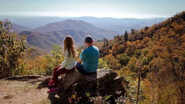 Padre e hija contemplan la montaña.