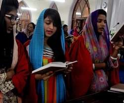 Jóvenes cristianas cantan himnos en una misa de Pascua en Karachi, Pakistán