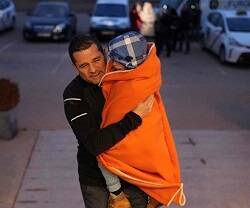 Un padre ucraniano huye con su hijo en brazos
