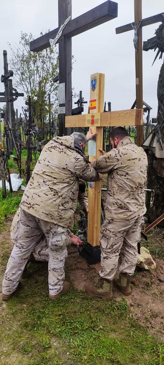 Soldados españoles colocan una cruz en la colina de las cruces