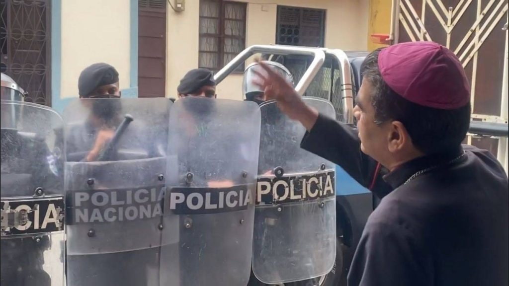 Obispo Rolando en verano de 2022 con policías cuando estaba en arresto domiciliario