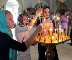 Jóvenes ortodoxas ponen velas en su iglesia - un 30 por ciento de los rusos siente la cercanía de Dios en su vida