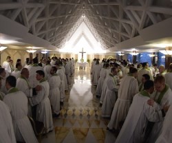 Los sacerdotes secretarios de Nuncios se dan la paz en la misa de Santa Marta