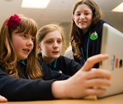 Un grupo de alumnas visualiza un contenido en una tableta