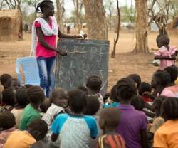 Una mujer enseñando a niños en África. 
