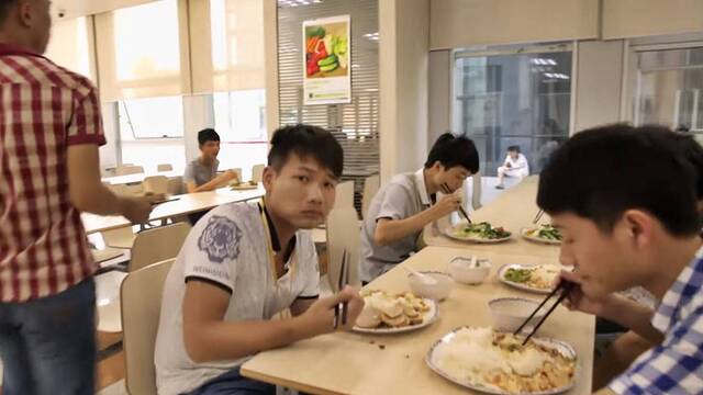 Jóvenes varones chinos en un comedor.